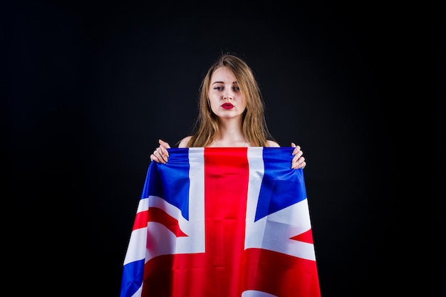 Photo cute girl with britain flag isolated on black background