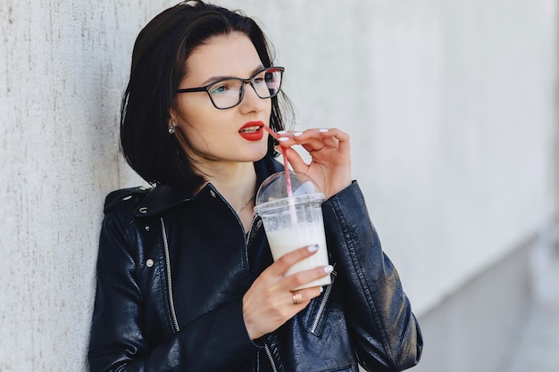 Cute girl with cold drink on sunny day