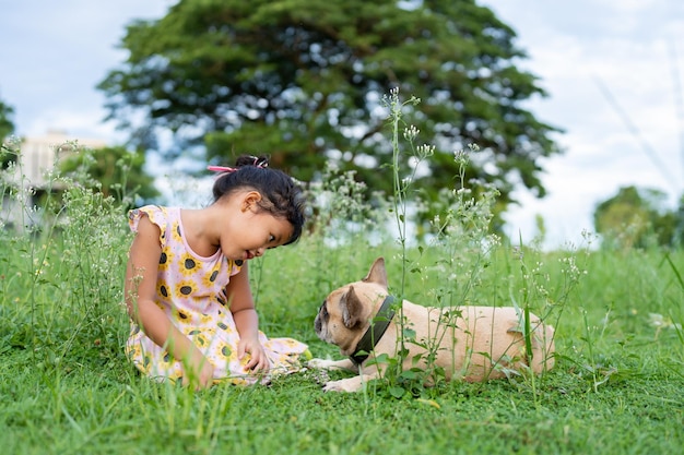 Cute girl with her dog at little ironweed field.