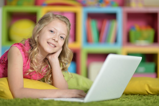 Cute girl with laptop at home