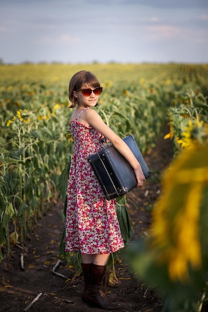 Cute girl with old suitcase