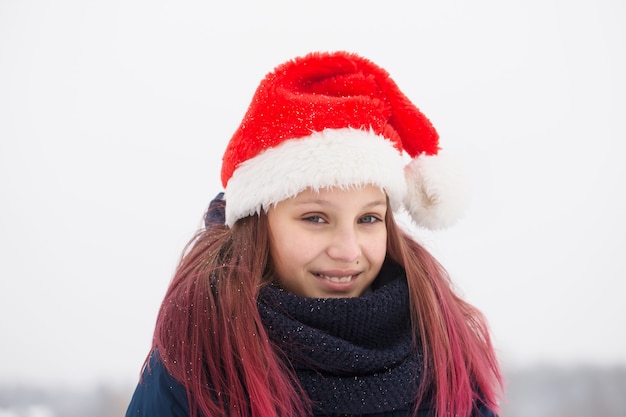Cute girl with pink hair in a santa