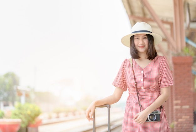 Cute girl with vintage camera and luggage 