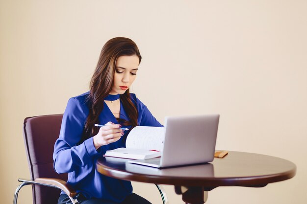 Cute girl works for a laptop