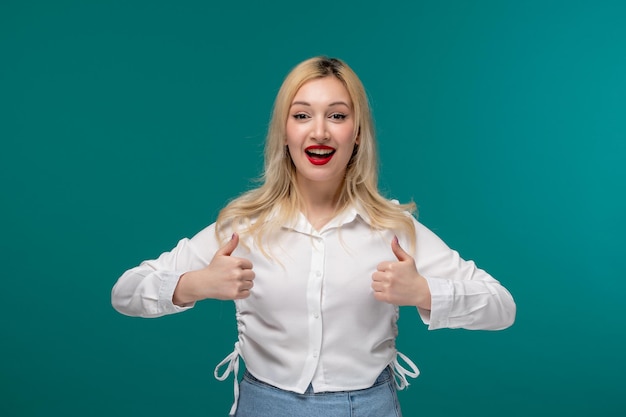 Cute girl young pretty blonde girl in a white shirt very cheerful holding good gesture