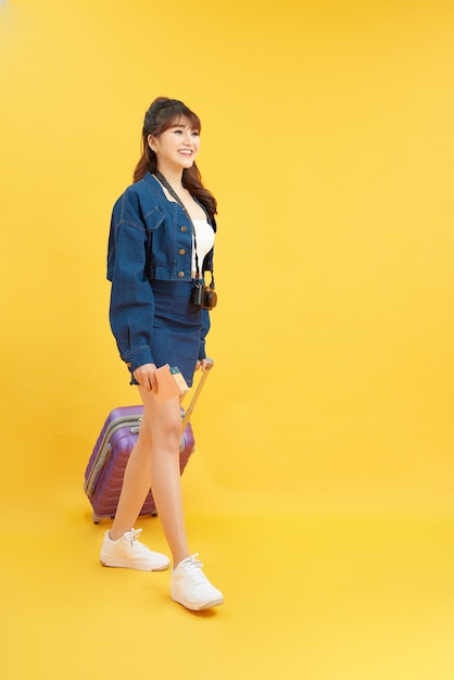 cute girlfriend ready to get on plane while isolated with vivid background