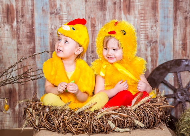 Cute girls play with real rabbit and duckling