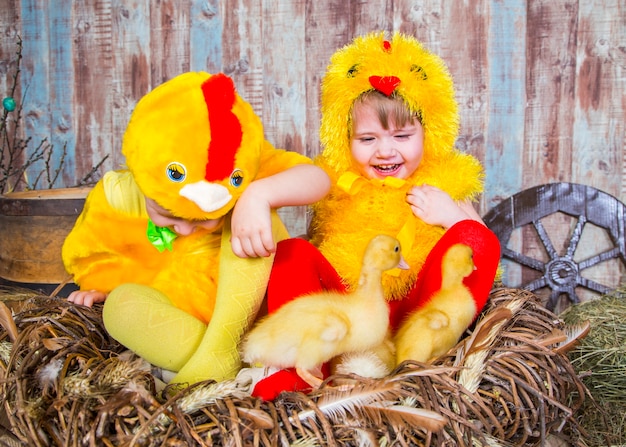 Cute girls play with real rabbit and duckling