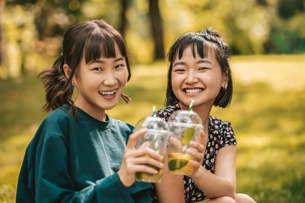 Cute girls spending time in the park and feeling happy