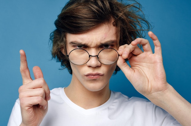 Cute guy with tousled hair wearing glasses fashion close up