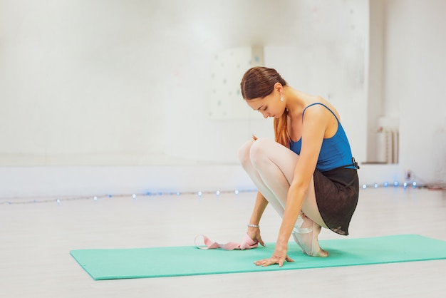 Cute gymnast engaged in training in the hall