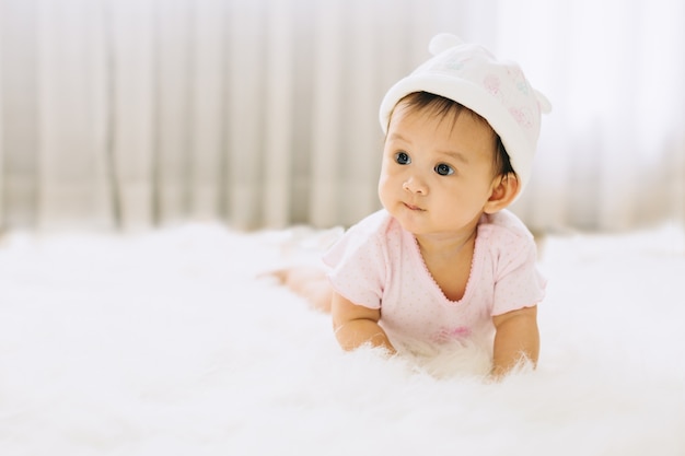 Cute and happy baby crawling on blanket. Creeping and craw are important developmental ste