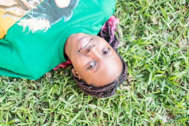 Cute happy black girl on summer grass meadow portrait