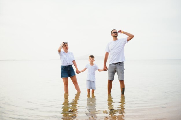 Cute happy family having fun on luxury tropical resort, mother with child, summer holidays, love concept