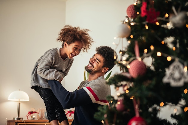 Cute happy girl playing with daddy at home