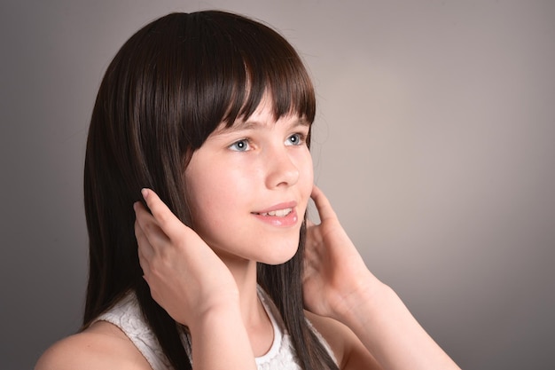 Cute happy girl with dark hair posing