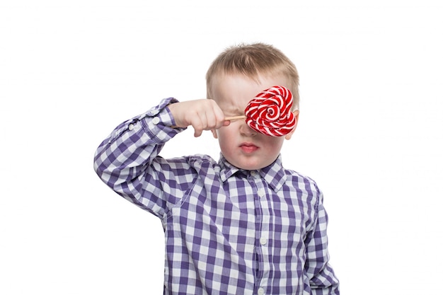 Cute happy little boy with lollipop 