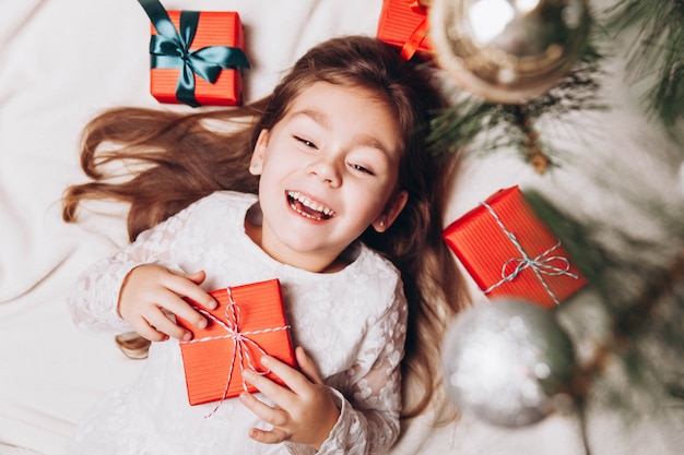 Cute happy little girl with gift boxes