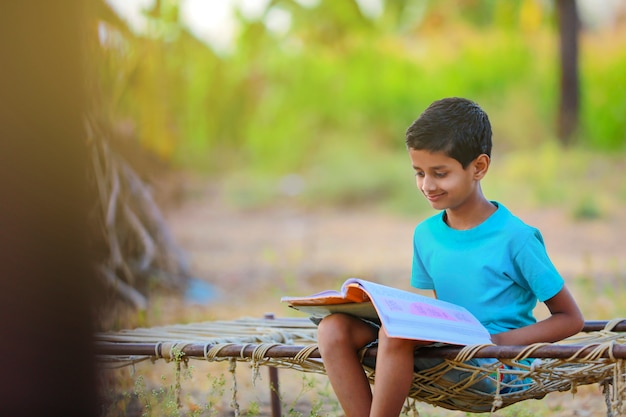 Cute indian child studying at home