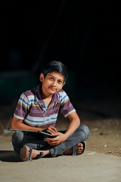 Premium Photo | Cute indian child writing on slate