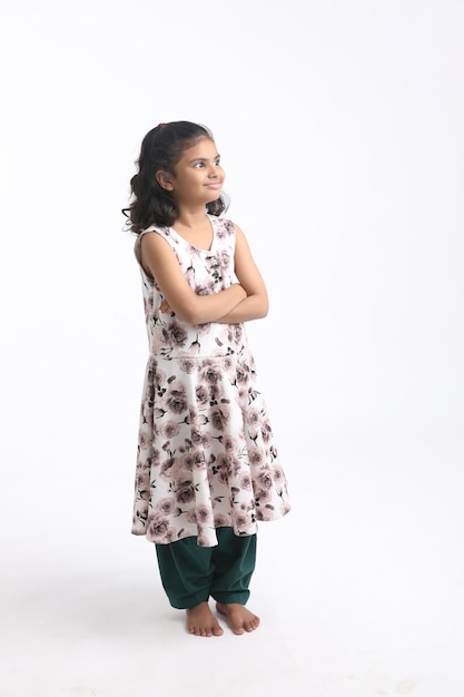 Cute Indian girl standing on white background