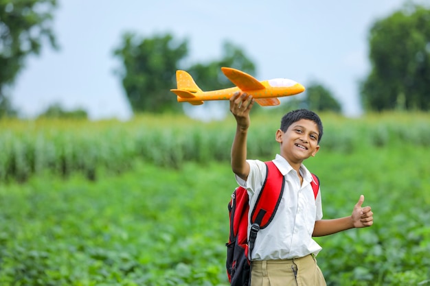 Cute Indian kid playing with a toy plane