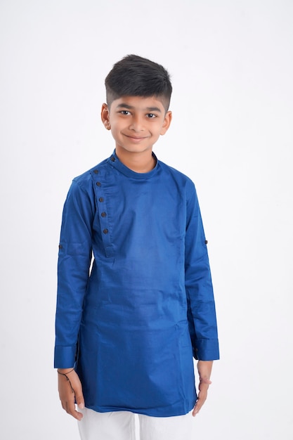 Cute indian little boy in ethnic wear and showing expression on white