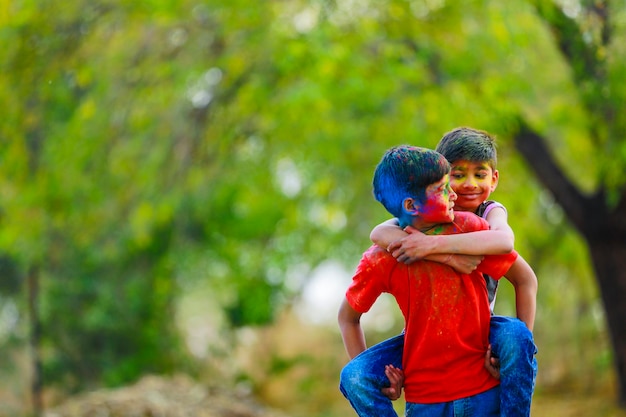 Cute indian little children playing holi. Holi is colors festival in india