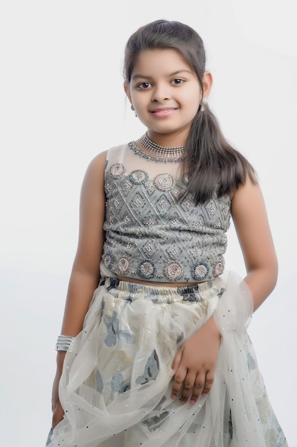 Cute indian little girl in ethnic wear and showing expression over white background