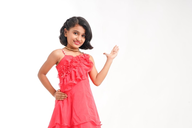 Cute indian little girl giving expression on white background