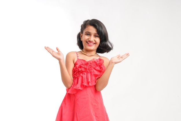 Cute indian little girl giving expression on white background