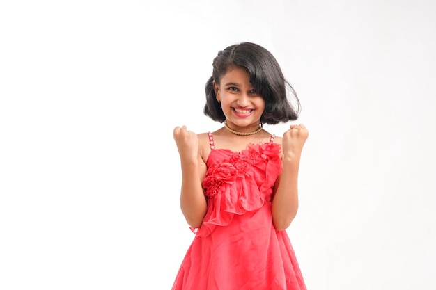 Cute indian little girl giving expression on white background