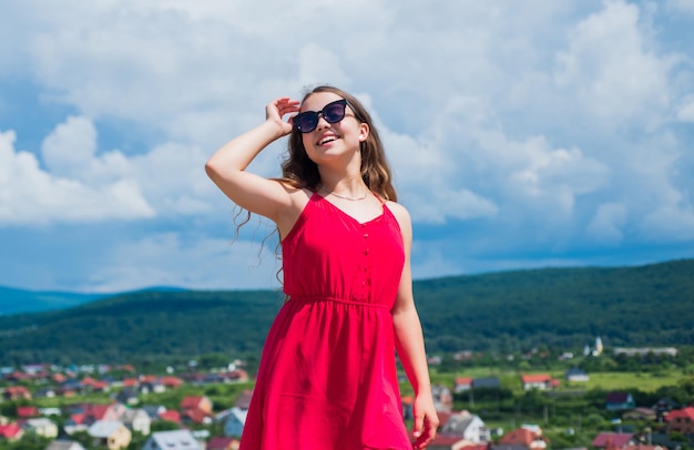 Cute kid in dress and glasses outdoor, summer fashion.