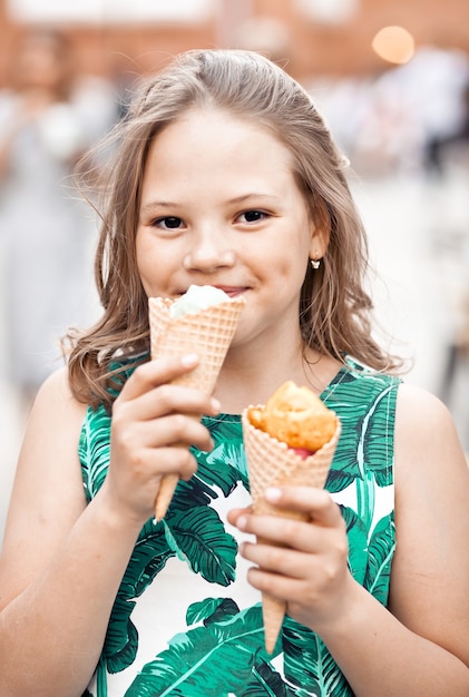 Cute kid girl eating ice cream cone