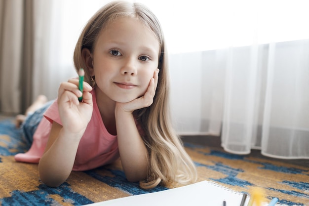 милый малыш маленькая девочка рисует дома