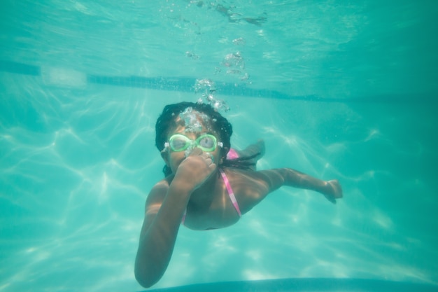 Cute kid posing underwater in pool