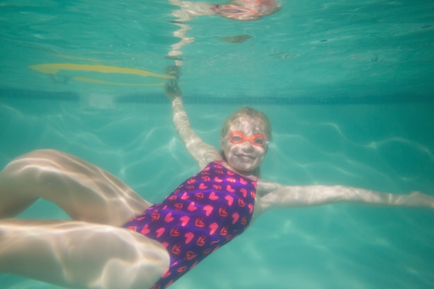 Cute kid posing underwater in pool