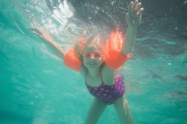 Cute kid posing underwater in pool