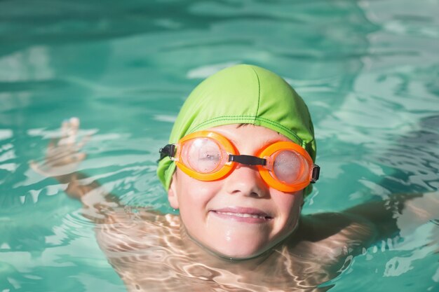 Cute kid swimming in the pool