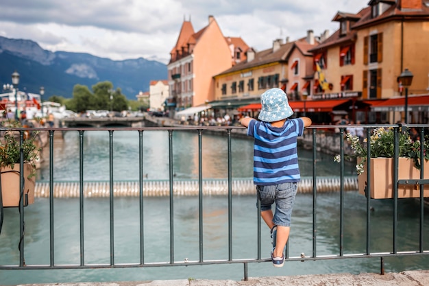 Cute kid walking in the old town of Annecy