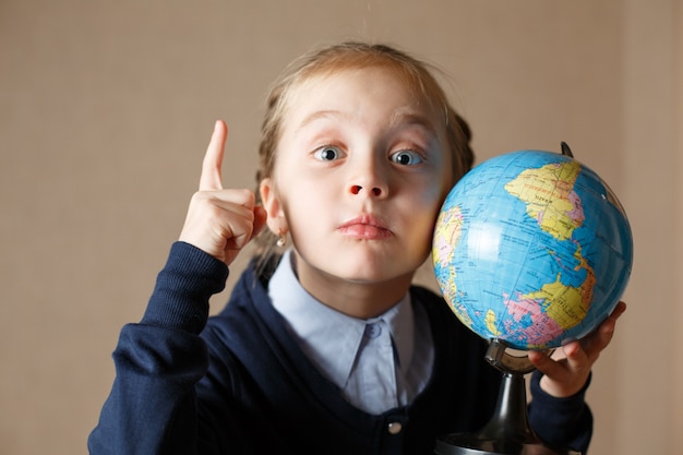 Cute kid with globe.