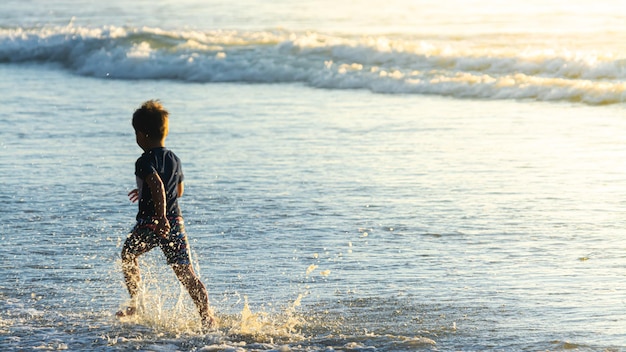 Cute kids having fun on sandy beach in summer