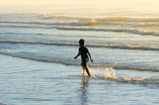 Cute kids having fun on sandy beach in summer