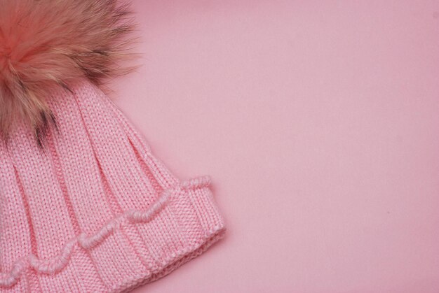 Cute knitted girl winter Pink hat isolated on Pink background