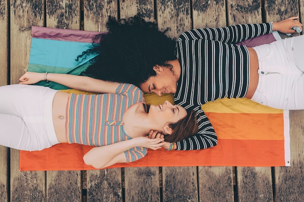 Cute lesbian couple lying together on the carpet  