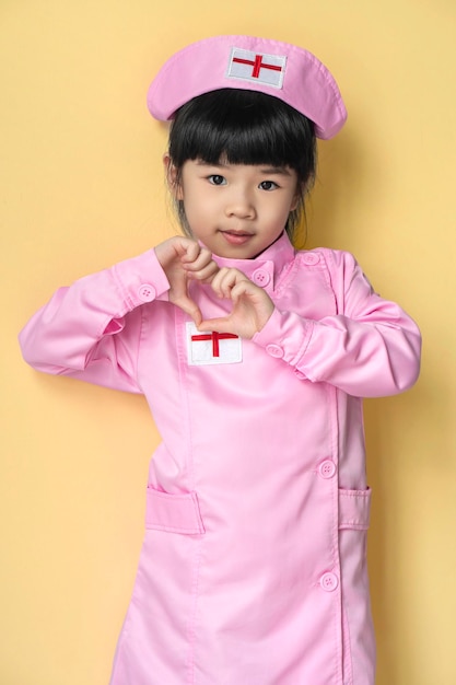 Cute little asian baby girl wearing nurse coat playing nurse