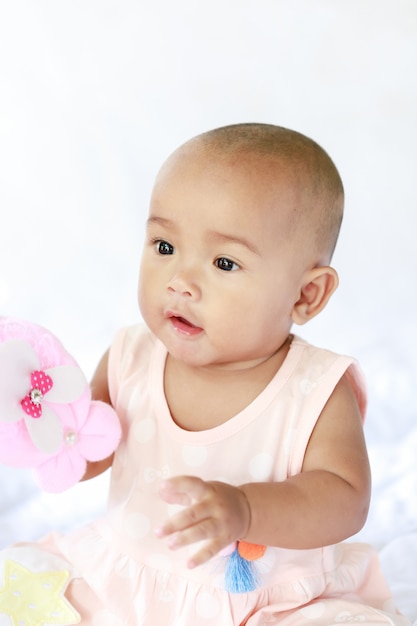 Cute little Asian baby sitting and play with happiness select focus shallow depth of field