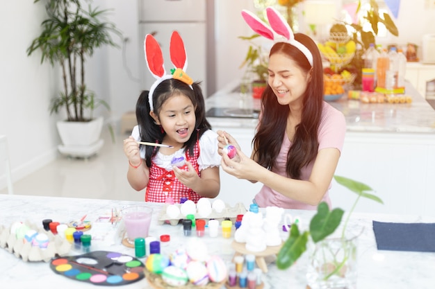 Cute little asian child girl wearing bunny ears on Easter day.