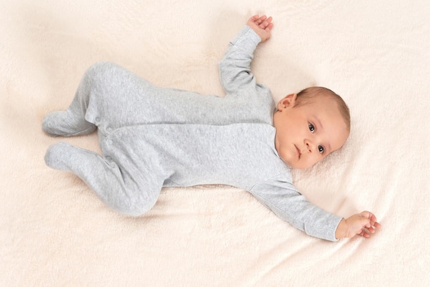 Cute little baby boy on bed