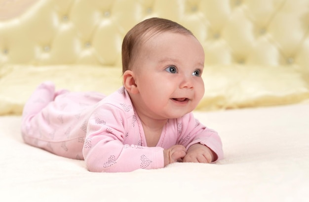 Cute little baby girl on bed